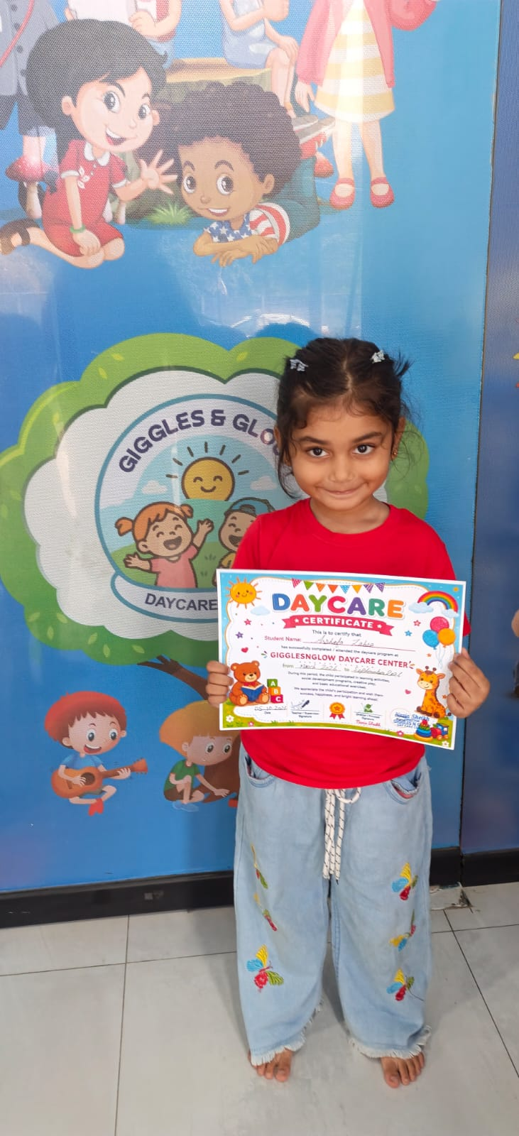 A little learner smiling with her Montessori certificate