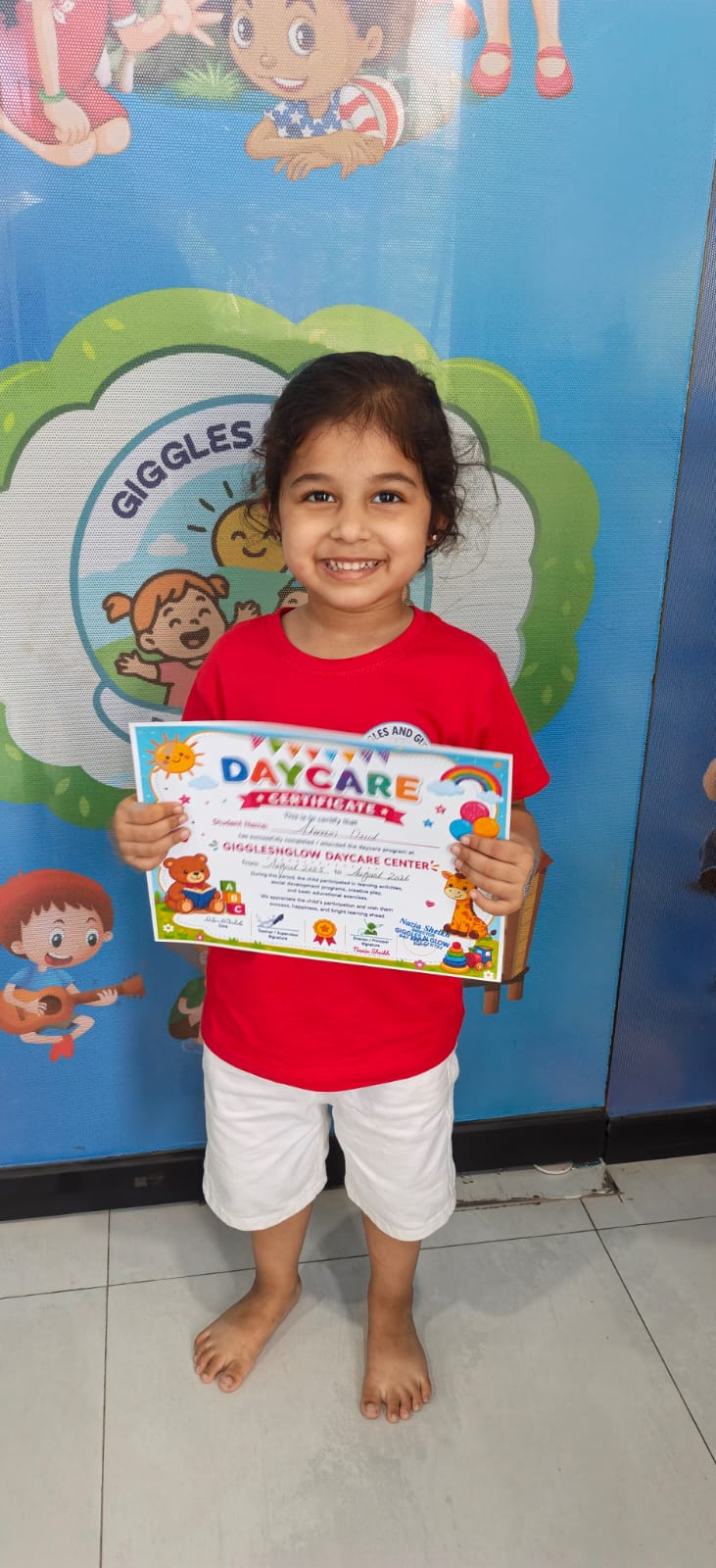 A little learner celebrating with her Montessori certificate