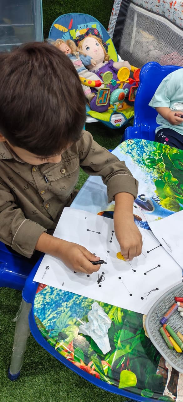 A child enjoying a tabletop creative activity