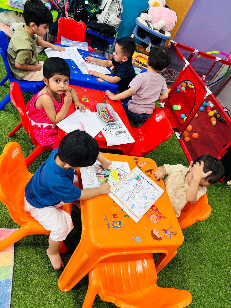 A child practising writing at the activity table