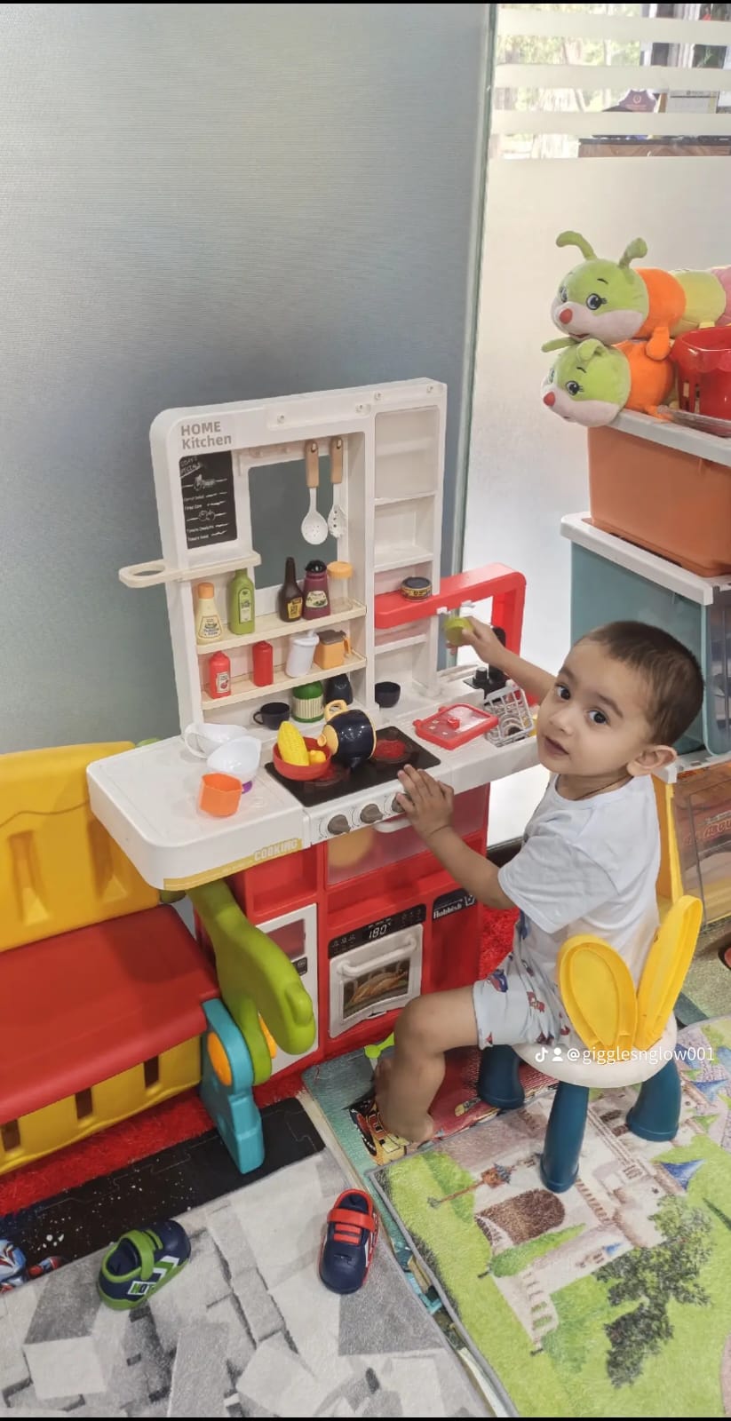 A toddler playing with toy fruit and vegetables